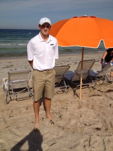 A person stands under an umbrella Description automatically generated with medium confidence