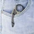 Kubey Mini Wrath Black Stonewash 14C28N Sandvik Tan G10 Folding Karambit clipped in pocket with finger ring visible