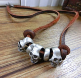 Triple titanium skulls leather necklace