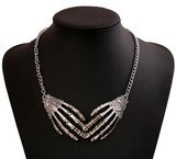 Skeletal hands necklace