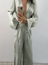 A stylish set of long sleeve blouse and high-waisted trousers