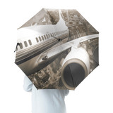 Departing Aircraft & City Scene behind Designed Umbrella