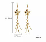 Gold tone flower dangle earrings
