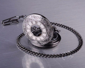 Roman Numeral Carvings on a Black Metal Pocket Watch