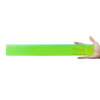 A transparent green 30cm ruler held in a hand, featuring both metric and imperial measurements.