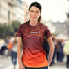 A women's performance t-shirt featuring a red and orange gradient design with a logo on the front.