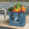 A blue tote bag filled with fresh vegetables and fruits, featuring black handles and a logo on the front.