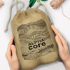 A large jute gift bag featuring decorative patterns and the text "ALPHA CORE - A GREAT PLACE TO LEARN."