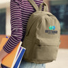 A khaki canvas backpack with a logo, being held by a person in a striped shirt, alongside some notebooks.