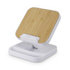 A wireless fast charging stand in white with a bamboo top, designed for phones and technology.