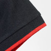 A black polo shirt featuring a red trim on the collar and sleeve. It has a branding logo.