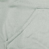 A close-up of a light green fabric featuring a seamless pocket, part of a hoodie design.