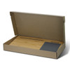 A bamboo lap desk in a cardboard box, featuring a sleek grey section and a smooth bamboo surface.
