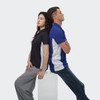 Two models wearing polo shirts, one in black and the other in blue with white accents, sitting back to back.