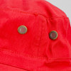 A close-up of a red wide brim hat featuring metal ventilation eyelets and a textured fabric.