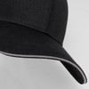 A black six-panel cap with a curved brim and contrasting trim, featuring a logo on the front.