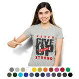 A woman wears a grey TRENDSWEAR women's T-shirt featuring motivational text and a logo. Numerous colours are shown beneath.