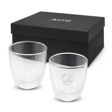A double wall glass set in clear glass, presented inside a black gift box, featuring a logo on each glass.