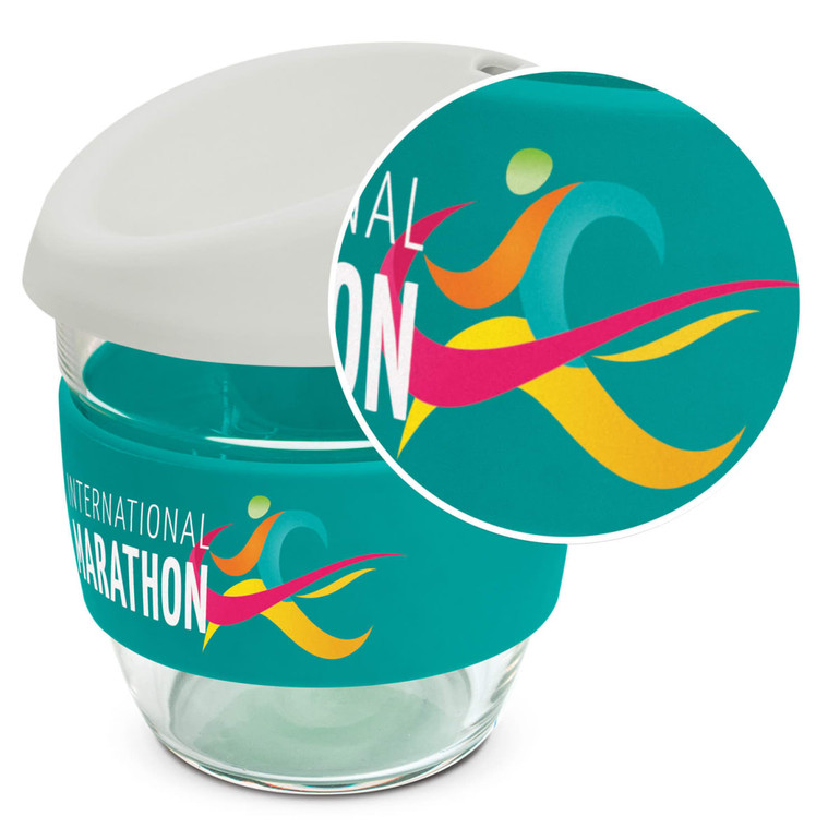 A drink bottle featuring a clear borosilicate glass body, a teal silicone sleeve, and a white lid with a logo.