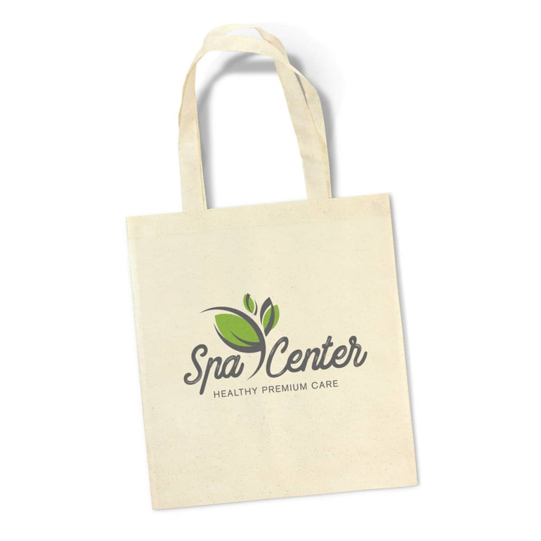A beige tote bag featuring a logo design with green leaves and text. The bag has two sturdy handles.