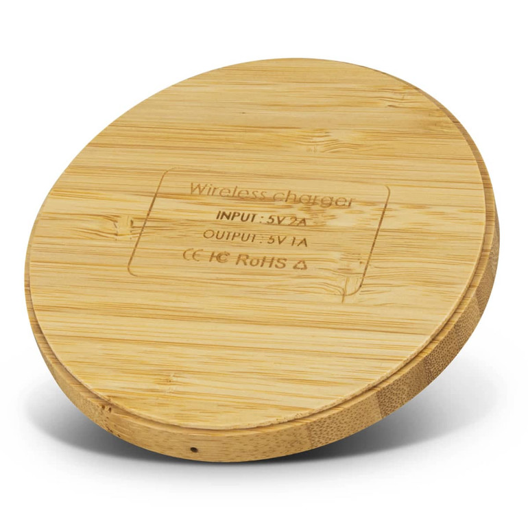 A round bamboo wireless charger with a smooth surface and a subtle engraved design. It has a natural finish and a logo.