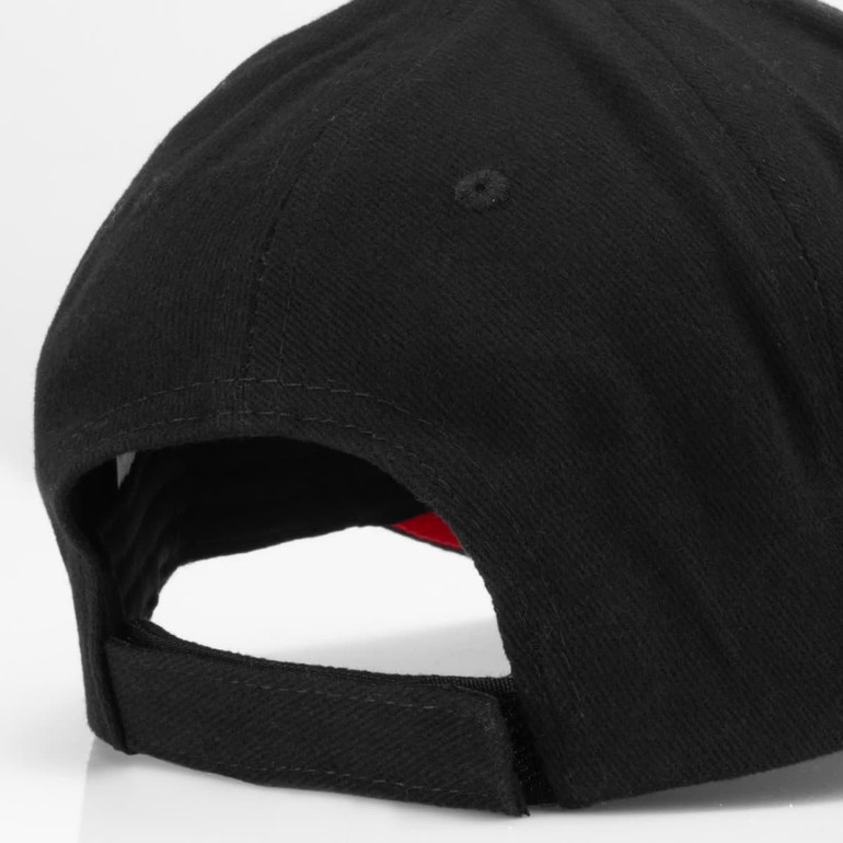 A black cap with a red interior, featuring a logo and an adjustable strap at the back.