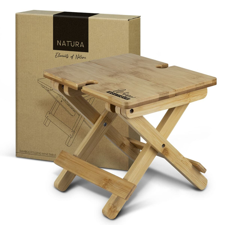 A bamboo folding wine table in a light natural colour, displayed alongside its branded packaging.