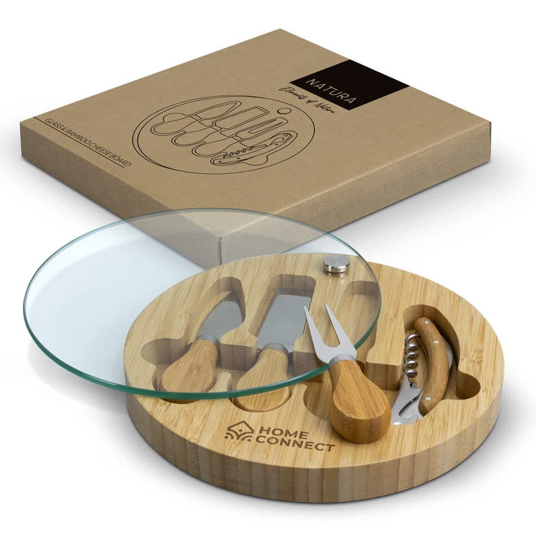 A bamboo cheese board with a glass top and wooden utensils, featuring a logo on the board.