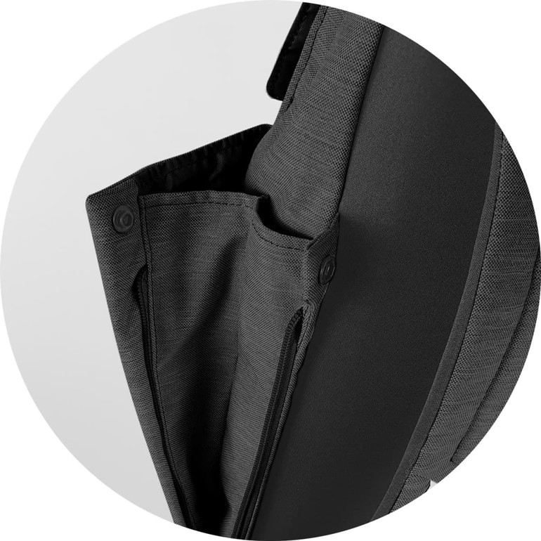 A black backpack flap featuring a zippered compartment and a button closure. It has a sleek, modern design.