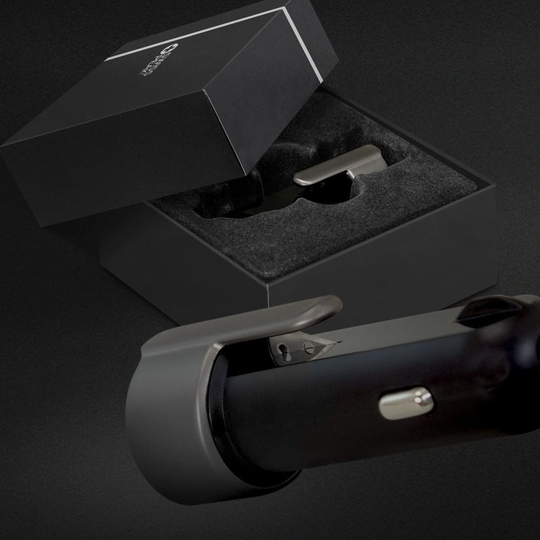 A black USB car charger with a sleek design, displayed in an elegant gift box with a velvet lining.