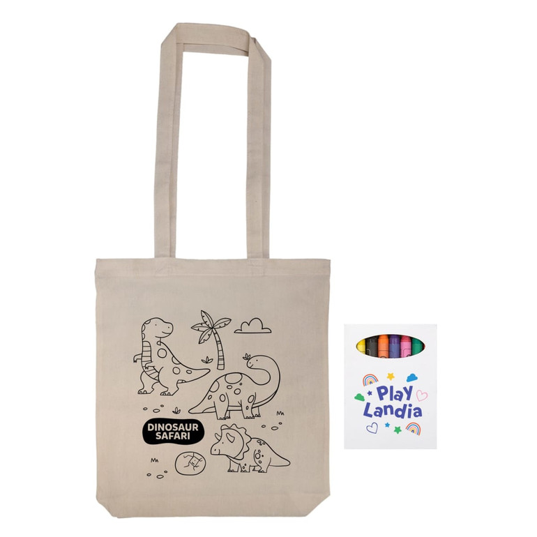 A beige reusable grocery bag with a dinosaur design and a set of crayons beside it. The bag has a logo.