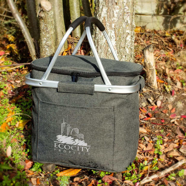A grey cooler basket with a silver frame and handle, featuring a logo on the front.