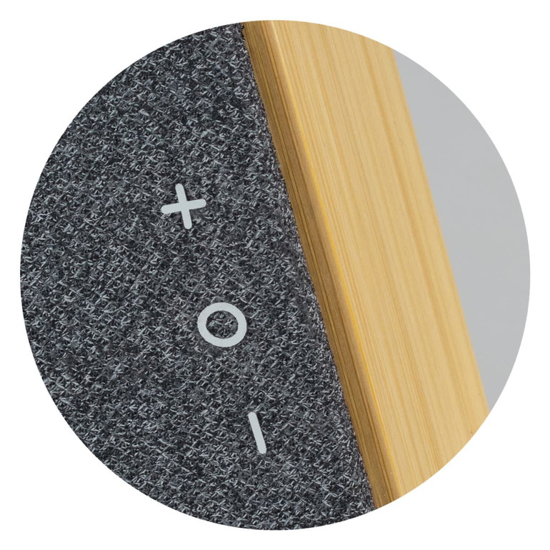 A close-up of a grey Bluetooth speaker featuring a bamboo detailing and volume control buttons.