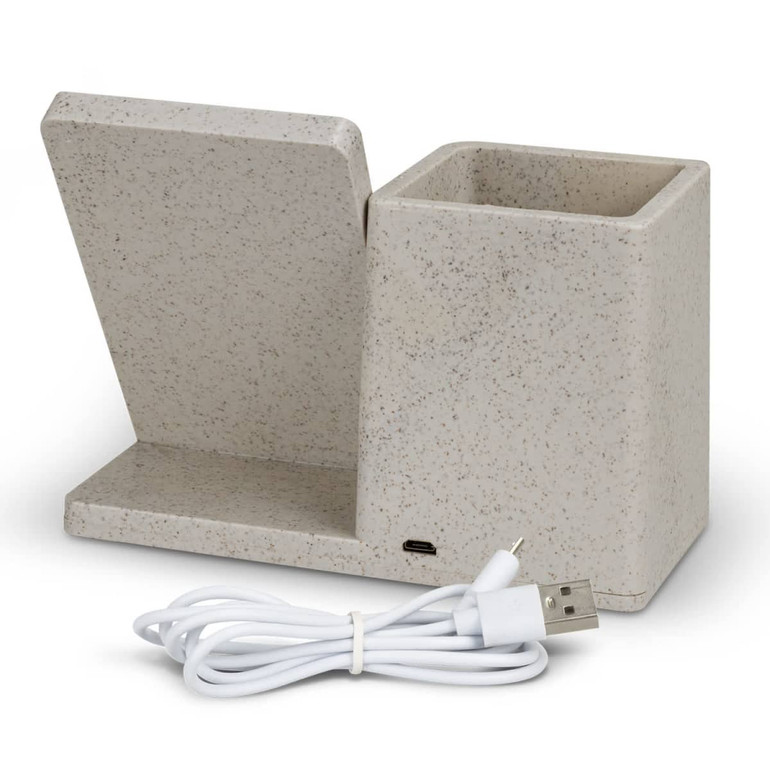 A beige wireless charger desk caddy with a slot for devices and a compartment for storage, accompanied by a USB charging cable.