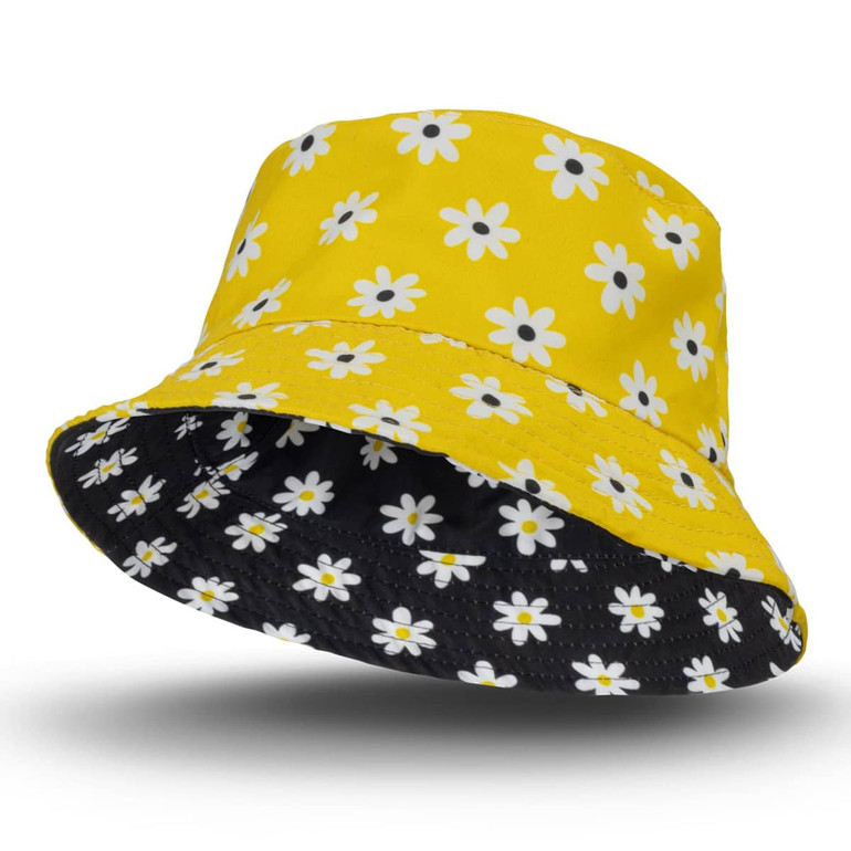 A yellow reversible bucket hat with a daisy pattern on one side and a solid black interior.