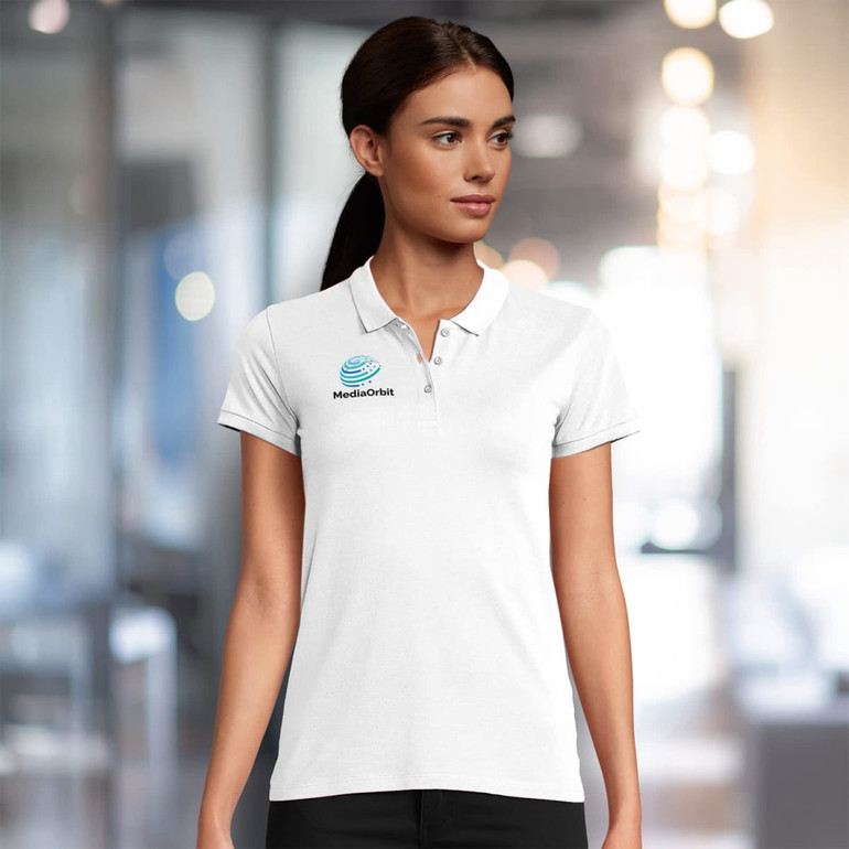 A women's polo shirt in white, featuring a logo on the left chest area. The shirt has a classic collar and short sleeves.