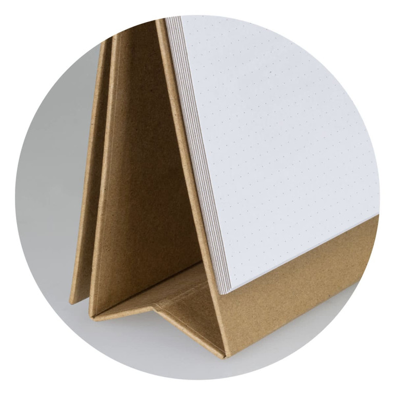 A desk whiteboard notebook featuring a brown cover and blank dotted pages, standing upright for easy access.