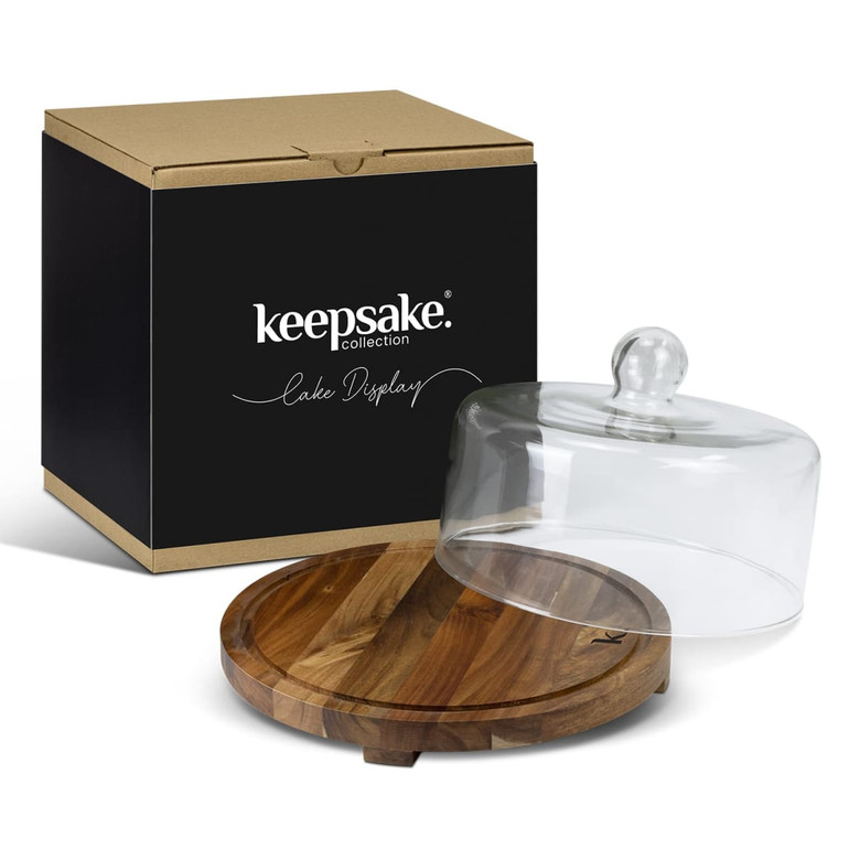 A glass cake display dome with a wooden base, packaged in a black box featuring a logo.