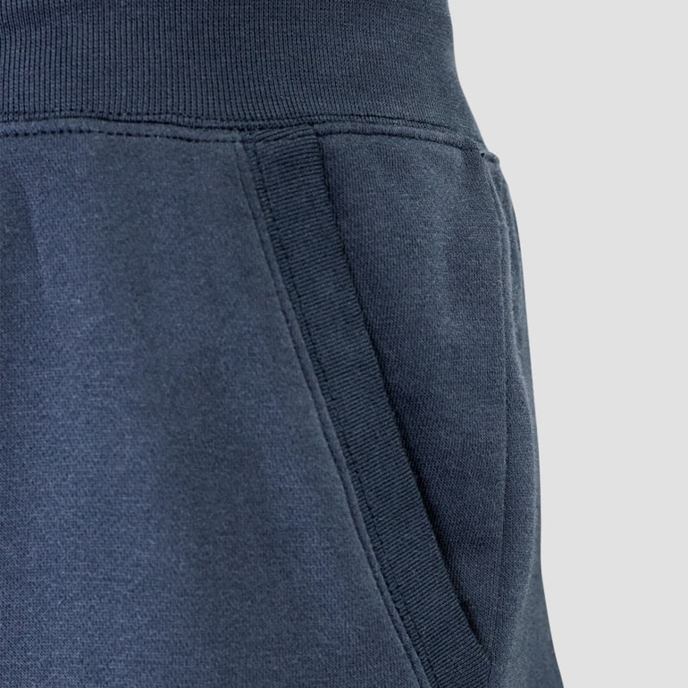 Dark navy unisex sweatpants featuring a side pocket and elastic waistband, with a subtle logo detail.