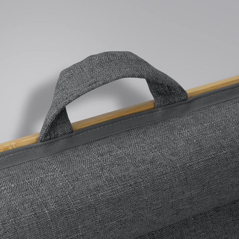 A grey fabric handle attached to a bamboo lap desk, highlighting the texture and natural material.