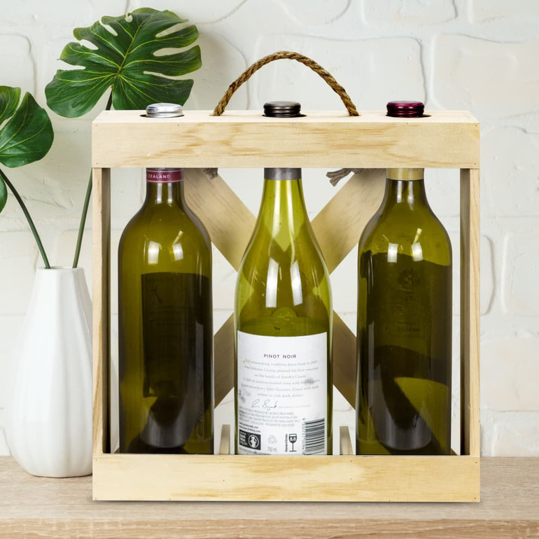 A wooden wine crate features three bottles of wine, including white and red, with a handle on top.