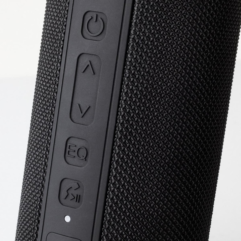 A black Bluetooth speaker featuring textured material and control buttons on the side. Contains a branding logo.