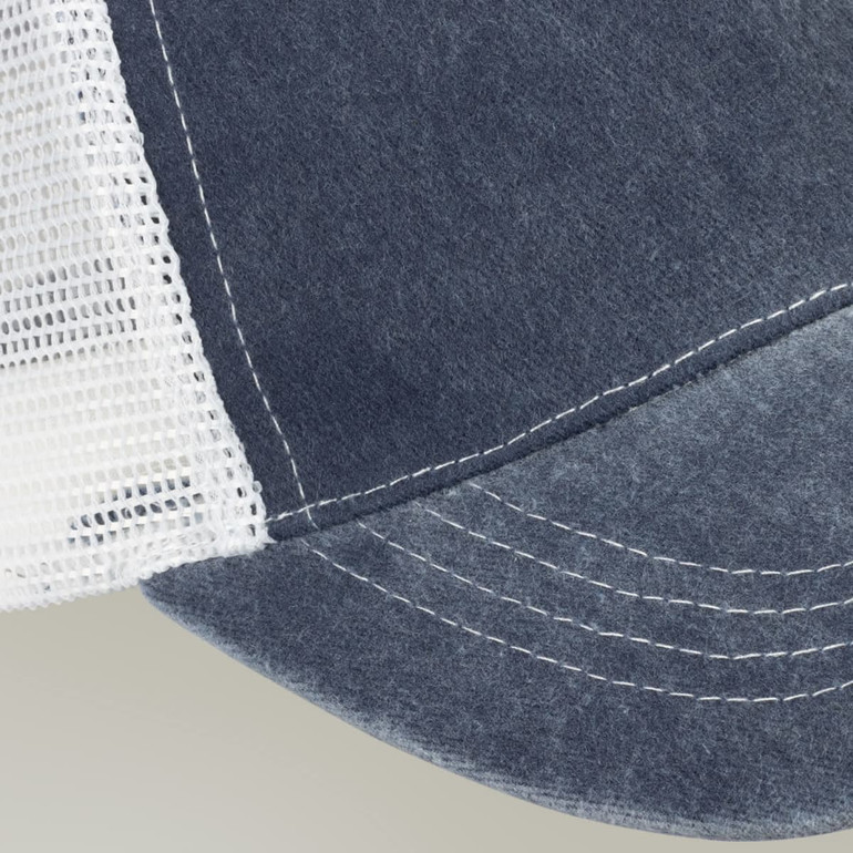 A faded navy blue trucker cap with a white mesh back and contrasting stitching. It features a logo on the front.