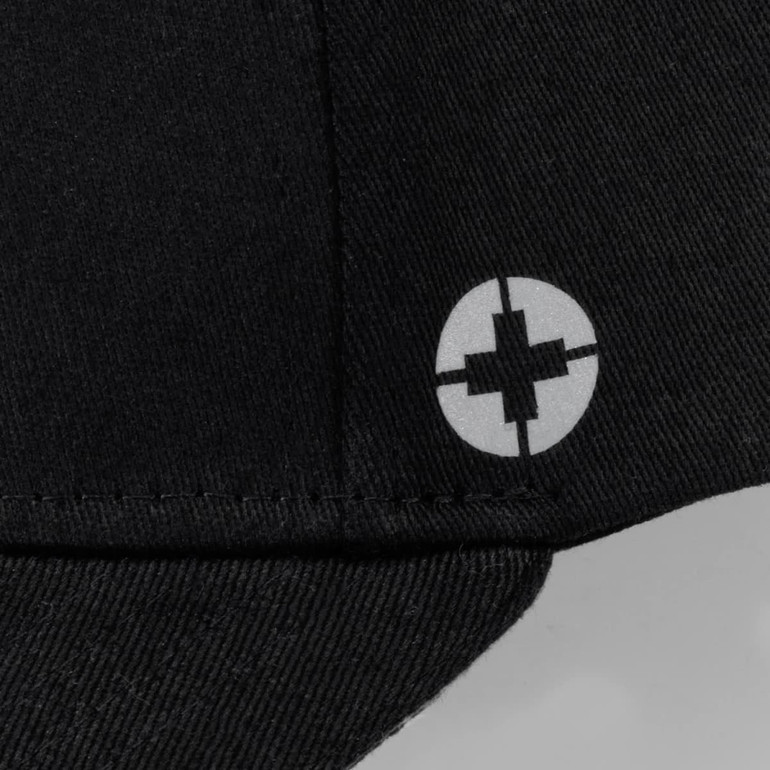 A black cap featuring a circular logo on the side. It has a six-panel design.