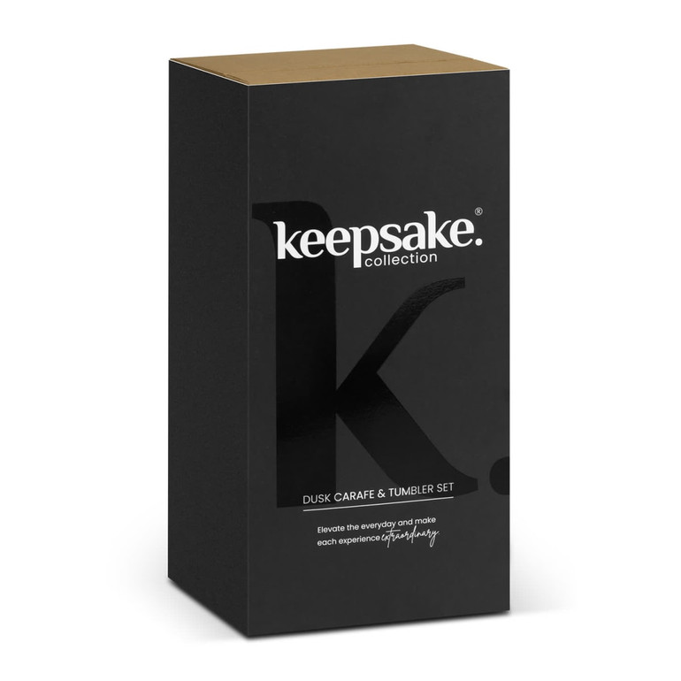 A black and gold box containing the Keepsake Dusk Carafe and Tumbler Set, featuring a branding logo.