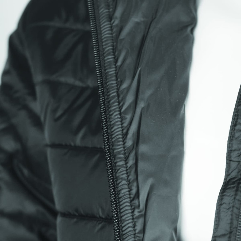 A black women's puffer jacket featuring a zip and quilted design, with a logo on the fabric.