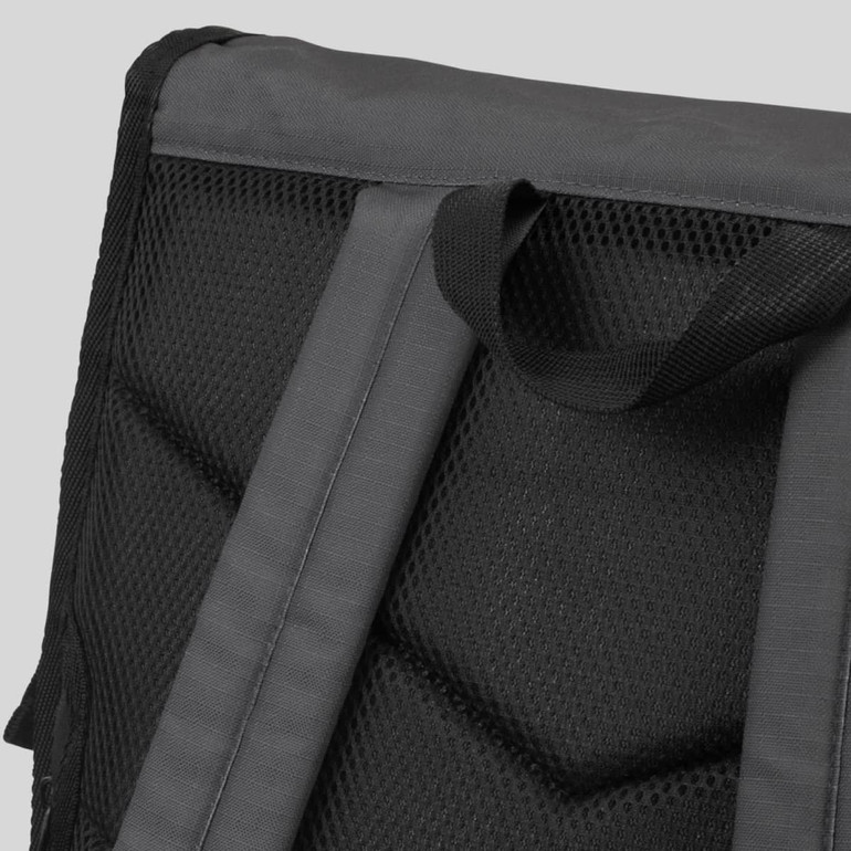 A black Fjord Backpack featuring a textured mesh back panel and padded shoulder straps.