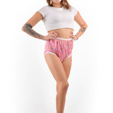 Model wears pink butterfly Silence Pants with her hands on her hips, facing forward. Model wears pink butterfly Silence Pants with her hands on her hips, facing forward.