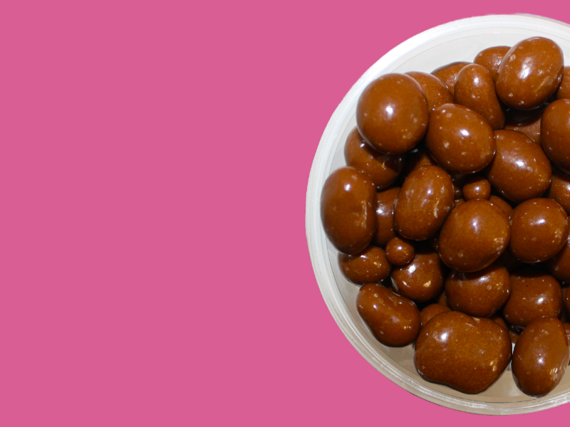 bowl of chocolate balls on pink background