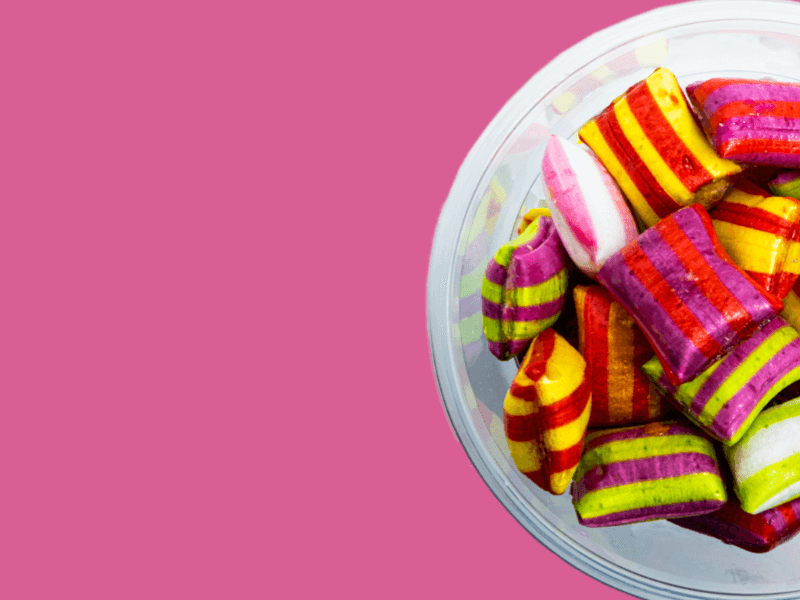 bowl of retro hard sweets on pink background